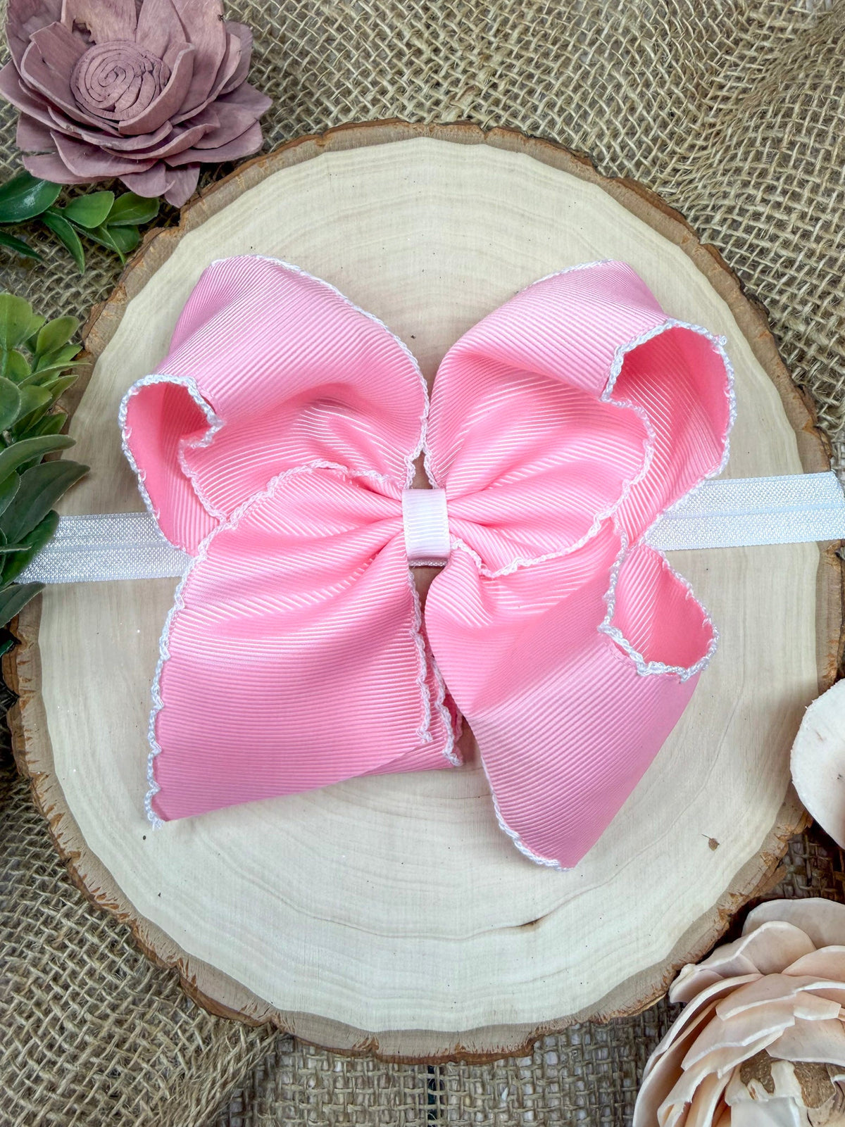 Pink classic moonstitch hair bow with decorative stitched edge