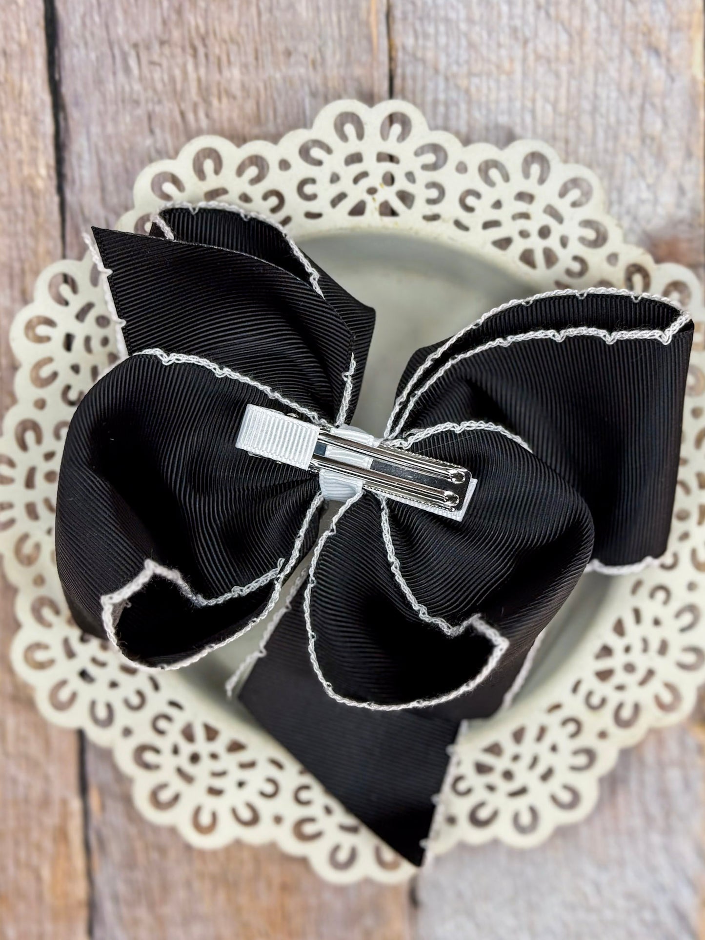 back of black and white moonstitch bow
