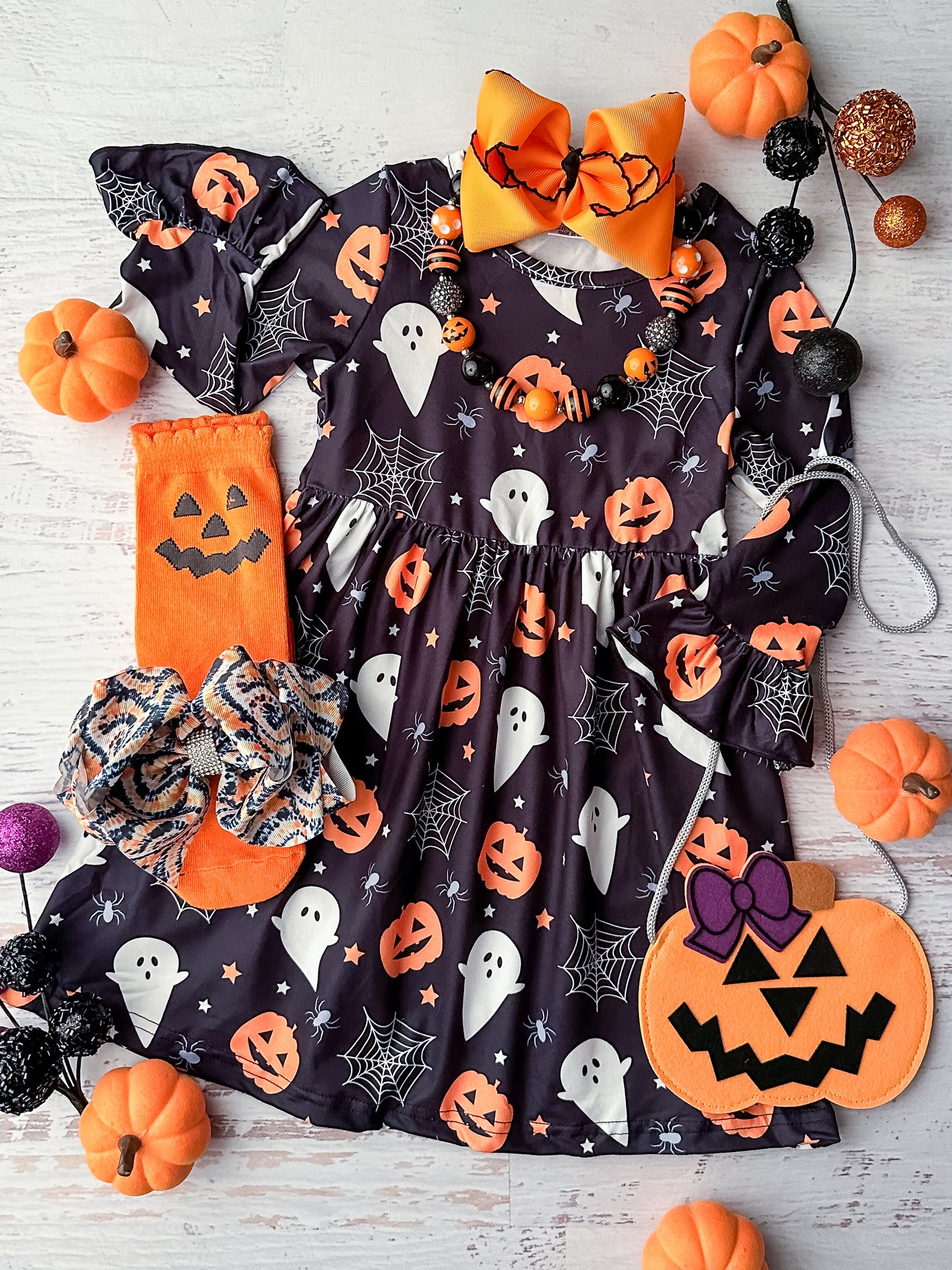 Black long sleeve dress in a ghost, pumpkin and spider web print.