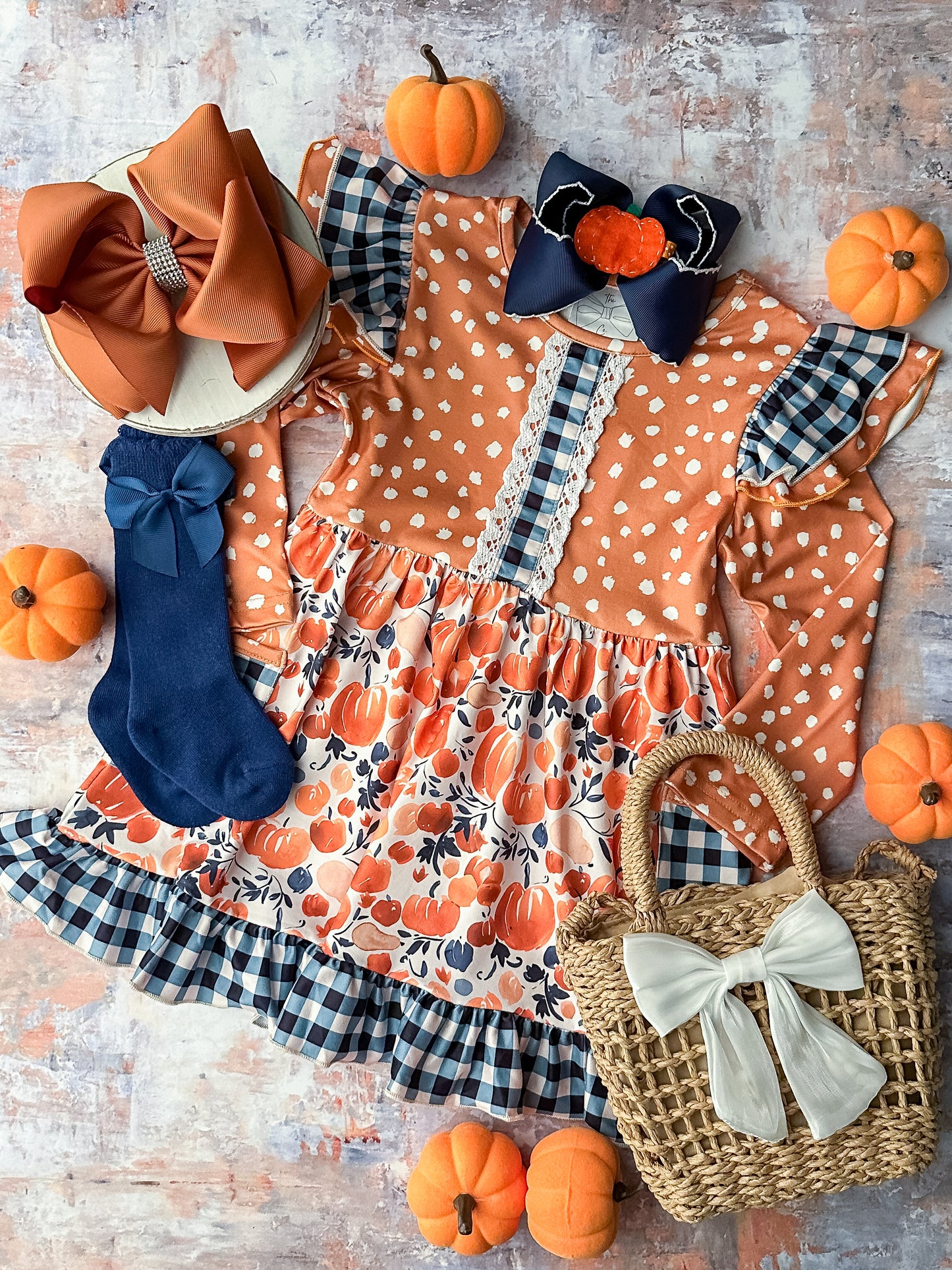 Long sleeve twirl dress with ruffle detailing in a mix of pumpkin and gingham prints.