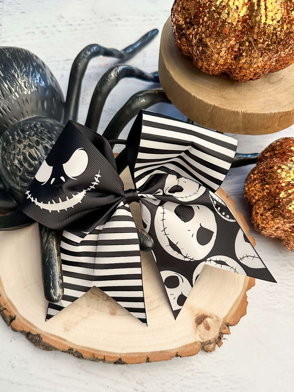 This Nightmare Before Christmas cheer bow features Jack Skellington faces and stripes.