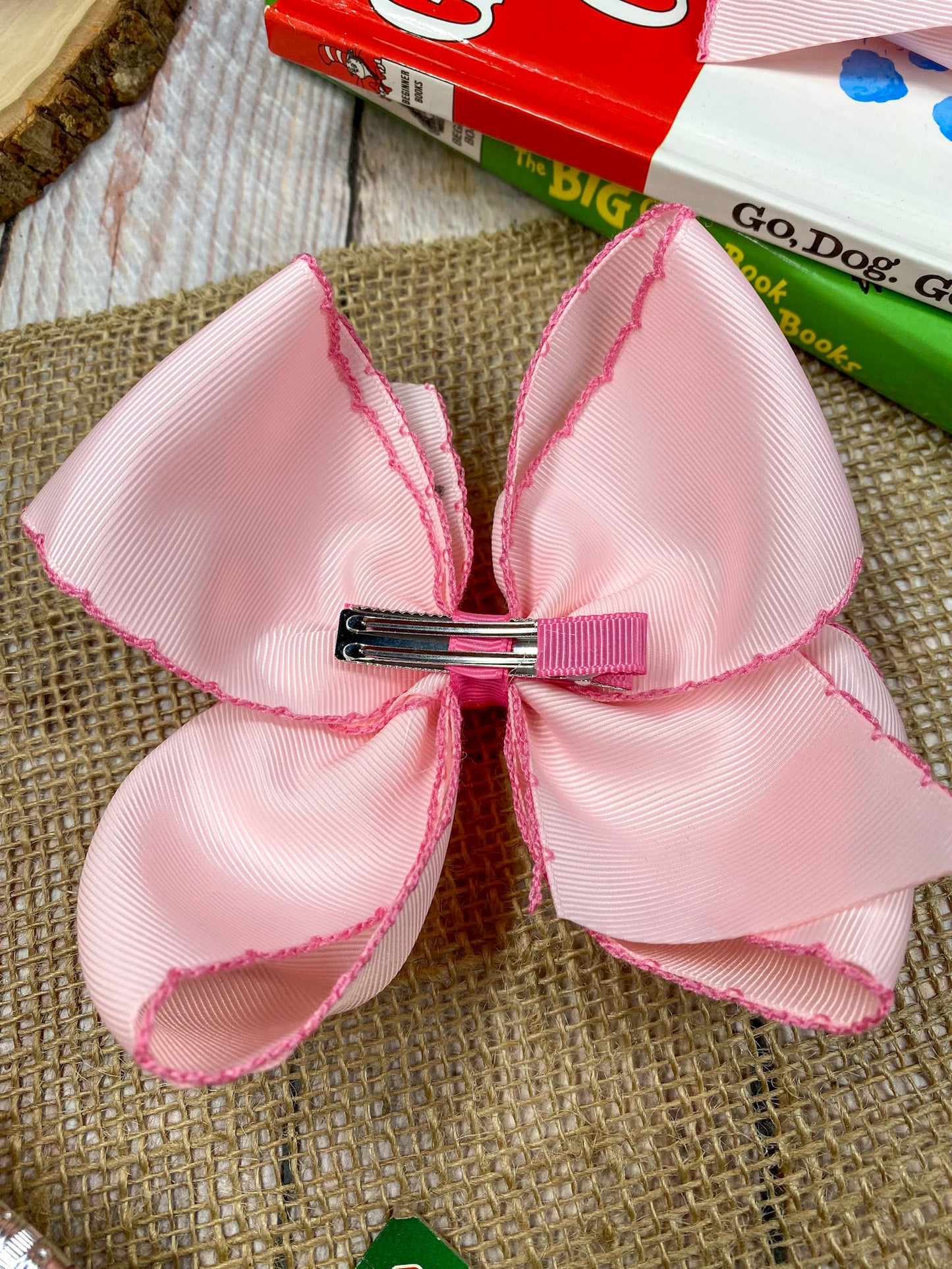 Pink School Grade Embroidered Cheer Bow on a wooden background