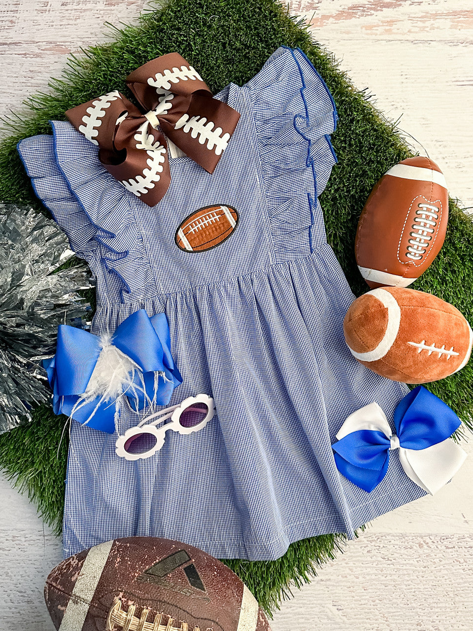 blue gingham dress with ruffled sleeves and a football
