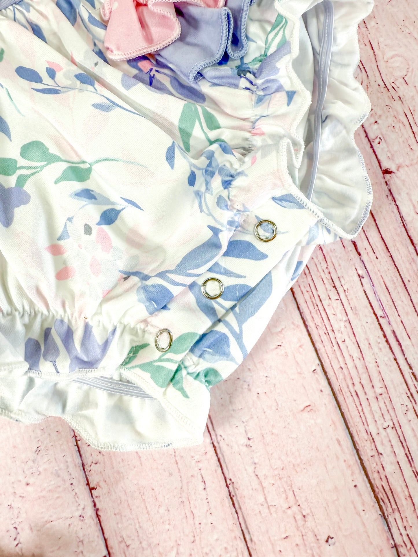 close up of buttons at bottom fo romper