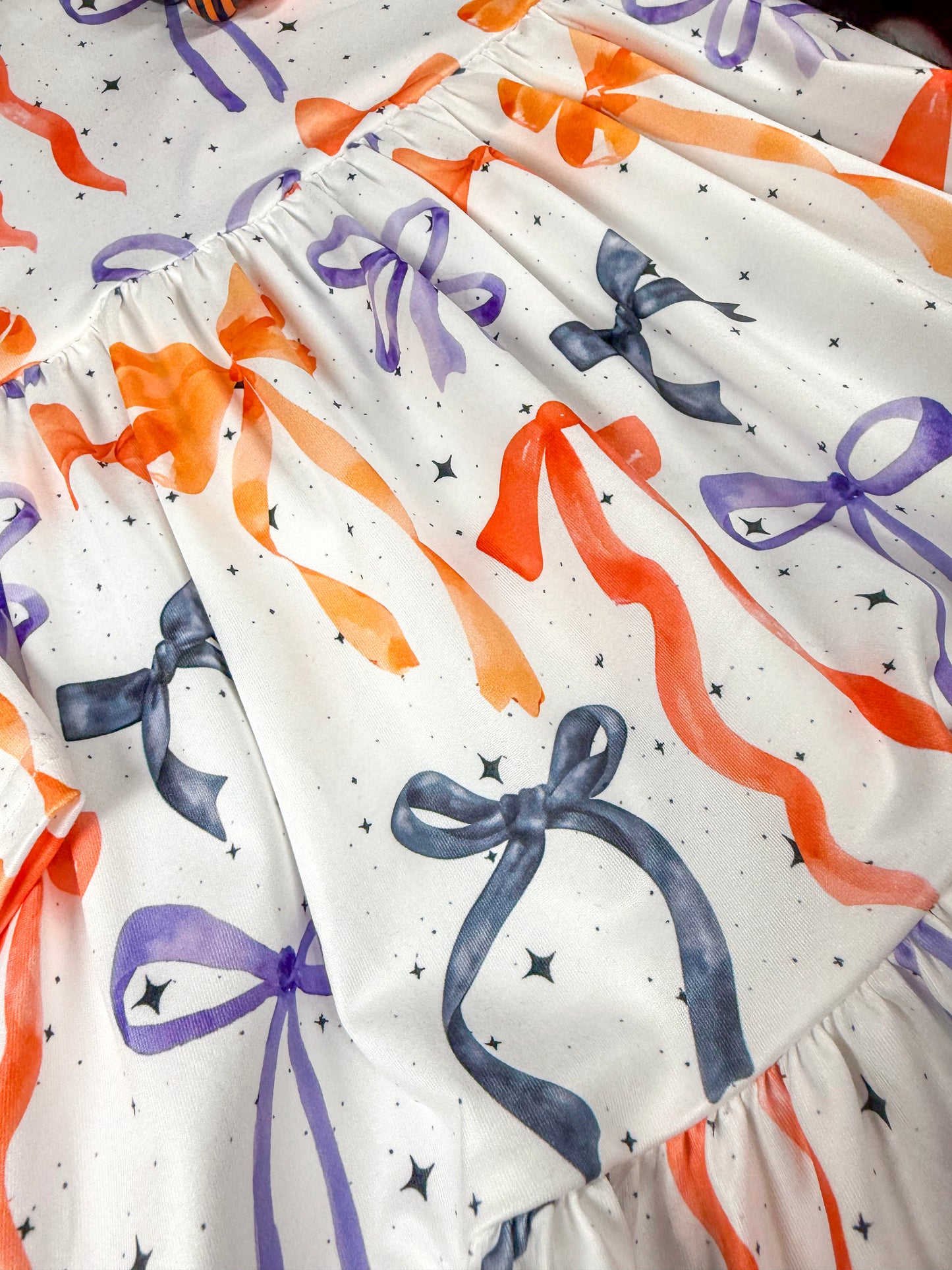 close up of bow pattern printed on dress