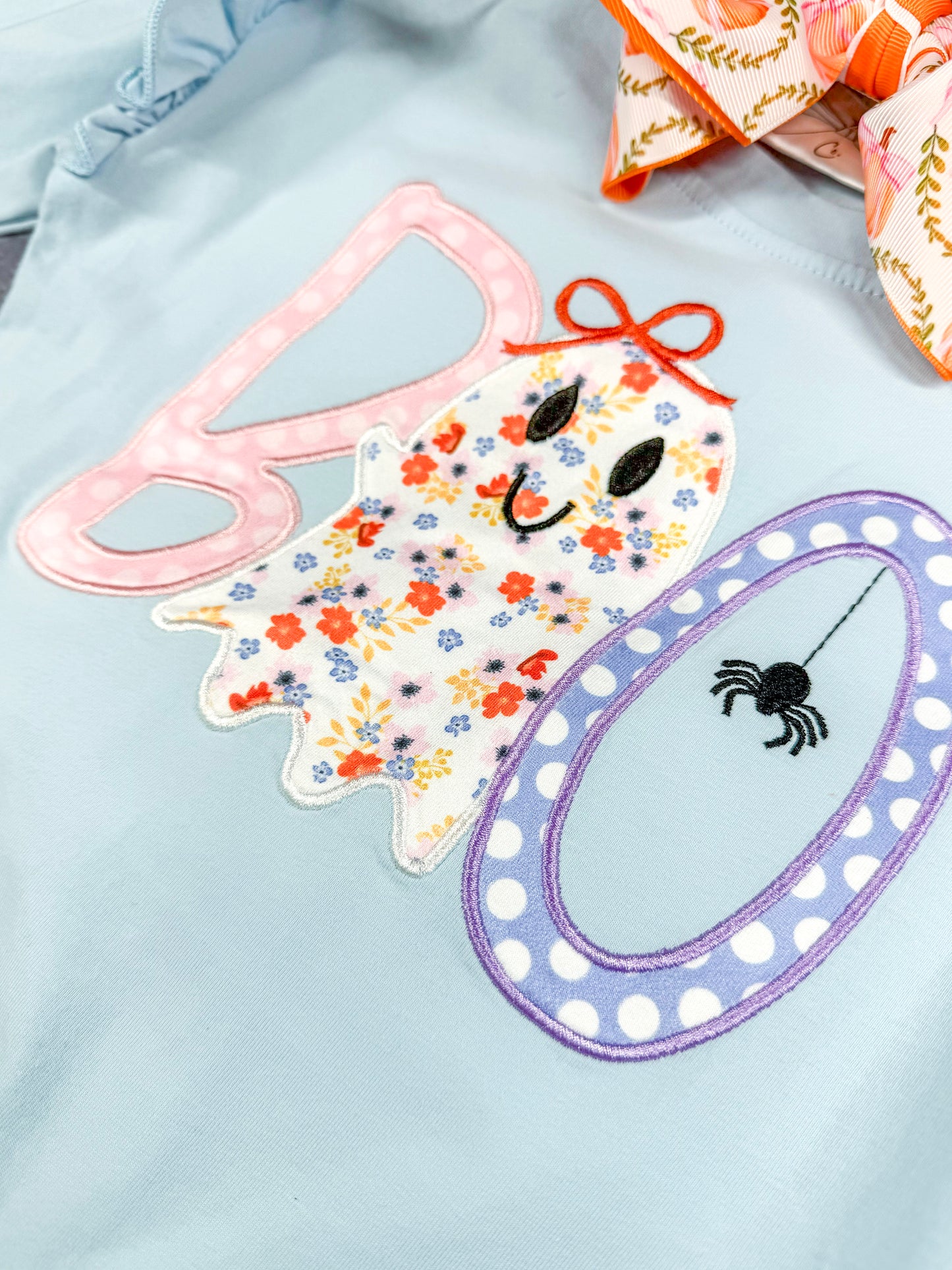 close up of the boo applique on front of the top