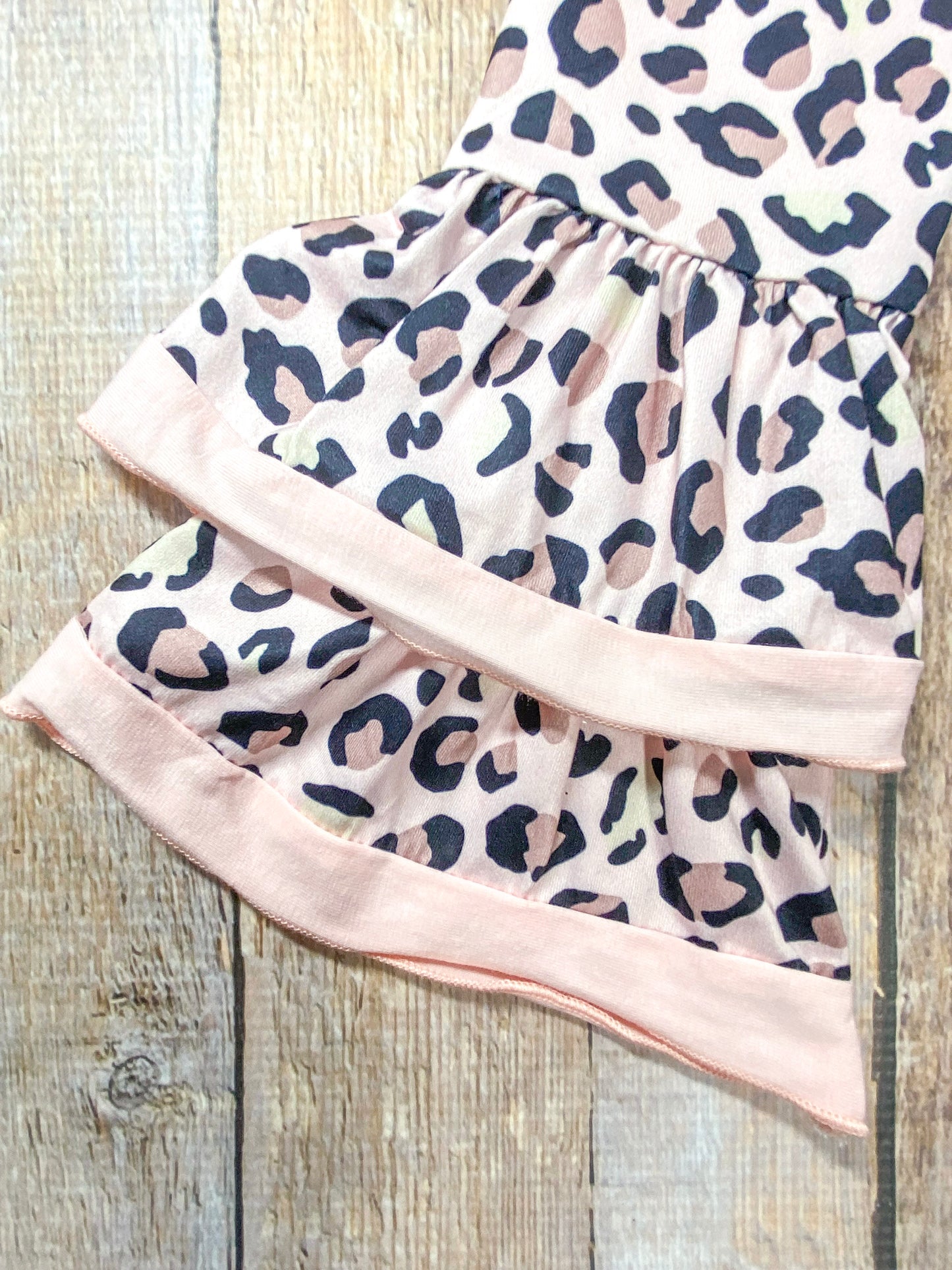 close up of the end of the double bell bottom animal print pants
