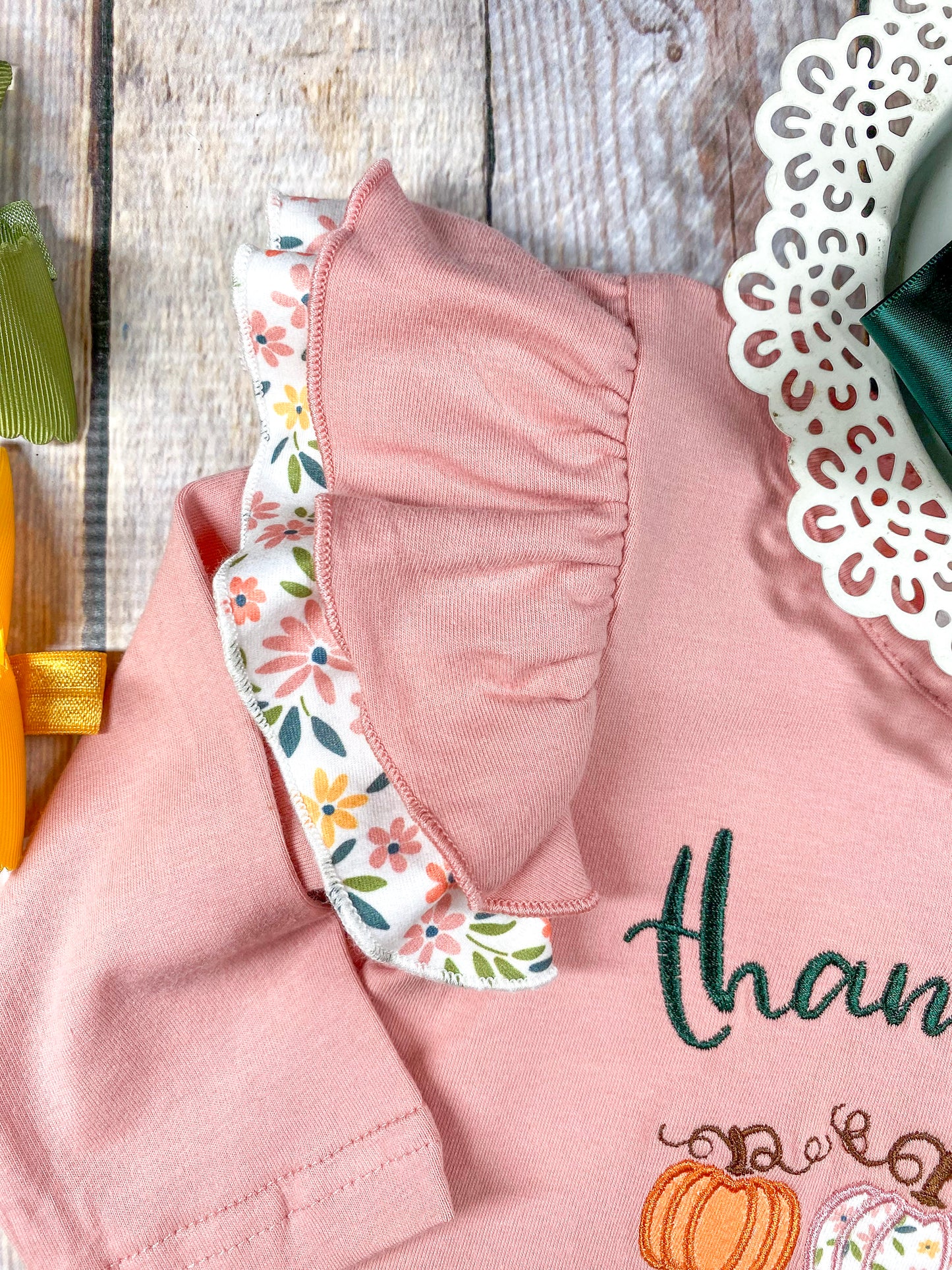 close up of the double ruffle on shoulder/top of sleeve where bottom ruffle is floral print