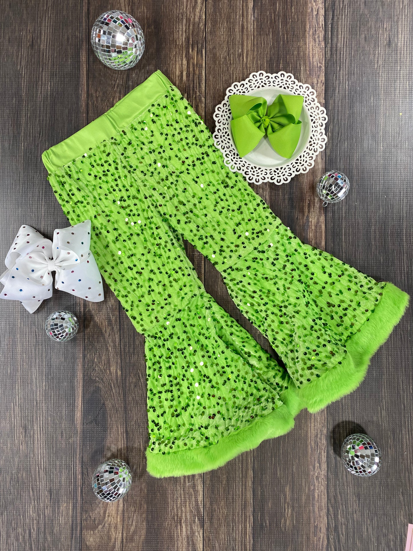 lime green sequin pants on wooden background