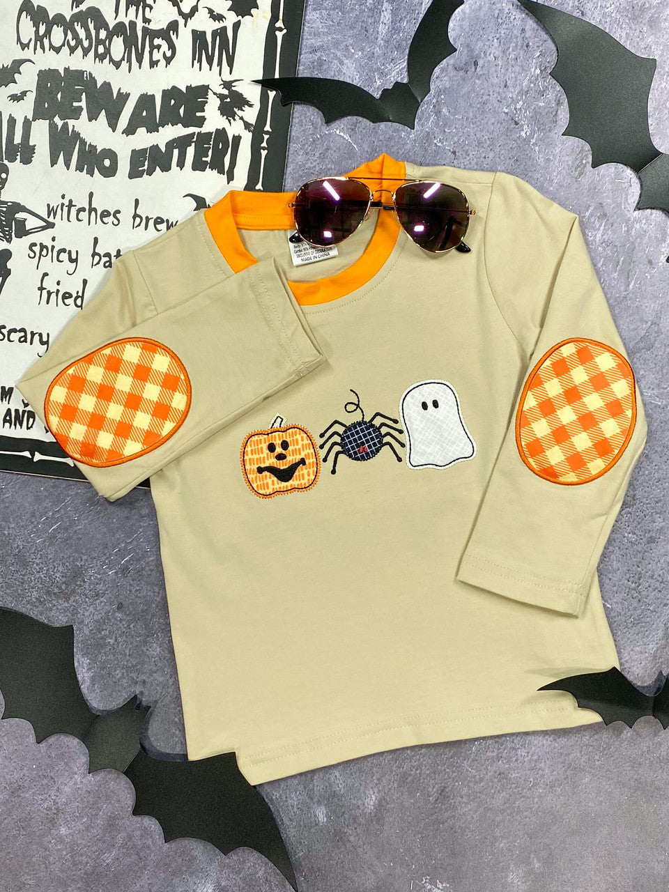 beige and orange shirt with jack-o-lantern, spider, and ghost