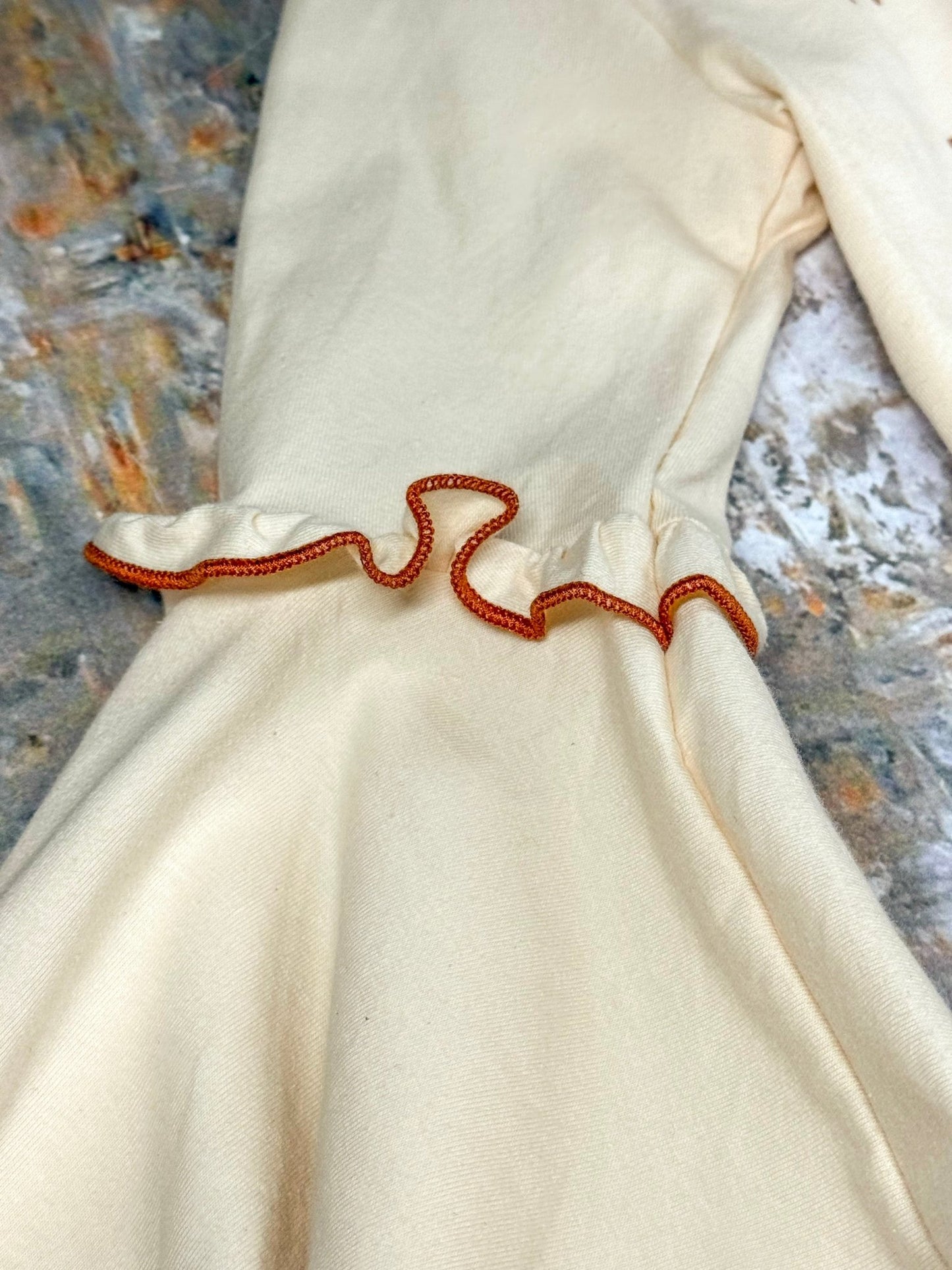 close up of stitching detail on the sleeve of top