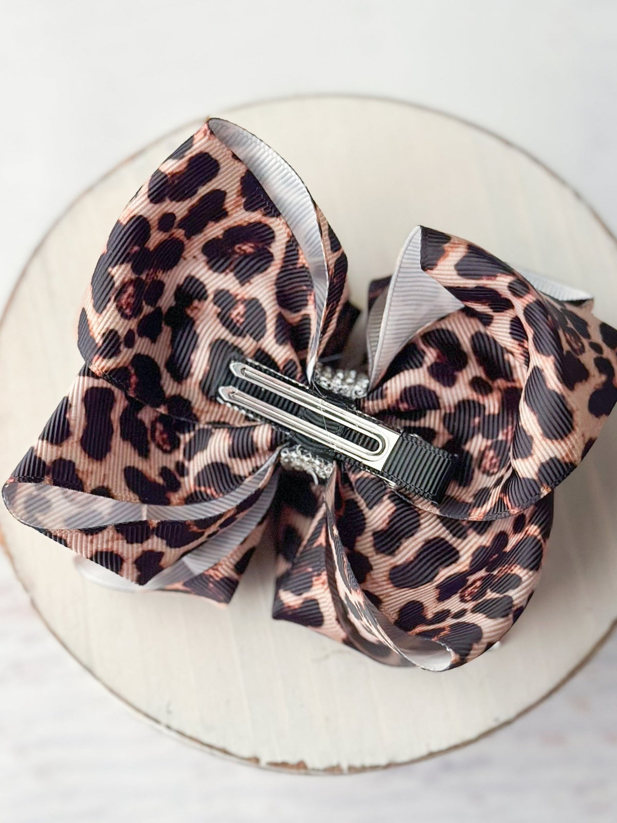 Back of leopard print hair bow showing double prong alligator clip