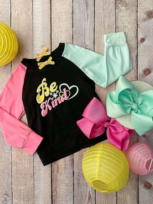 Be kind long sleeve top with a black bodice, one pink sleeve and one mint sleeve. - Alternative view