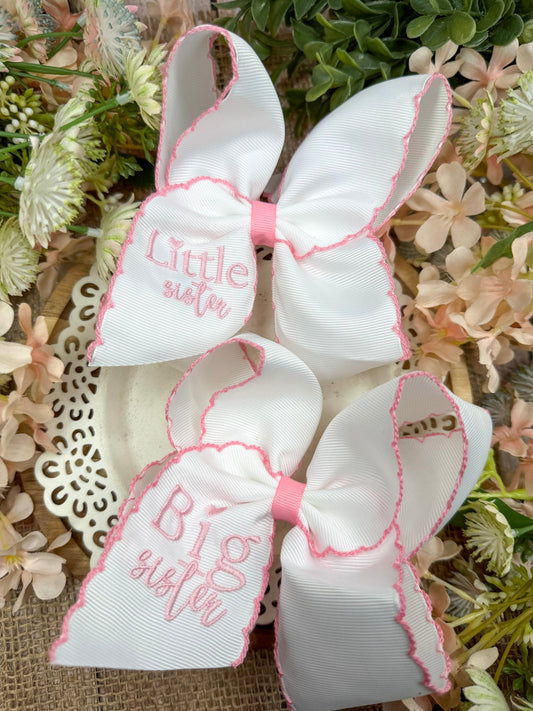 Matching Big Sister and Little Sister white embroidered hair bows with pink lettering and scalloped pink edges, displayed together. - Alternative view