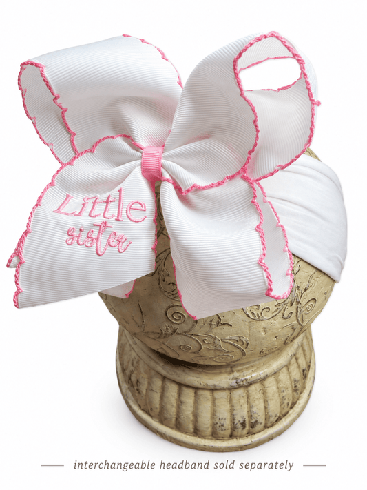 Matching Little Sister white embroidered hair bows with pink lettering and scalloped pink edges, displayed on an interchangeable headband. - Alternative view