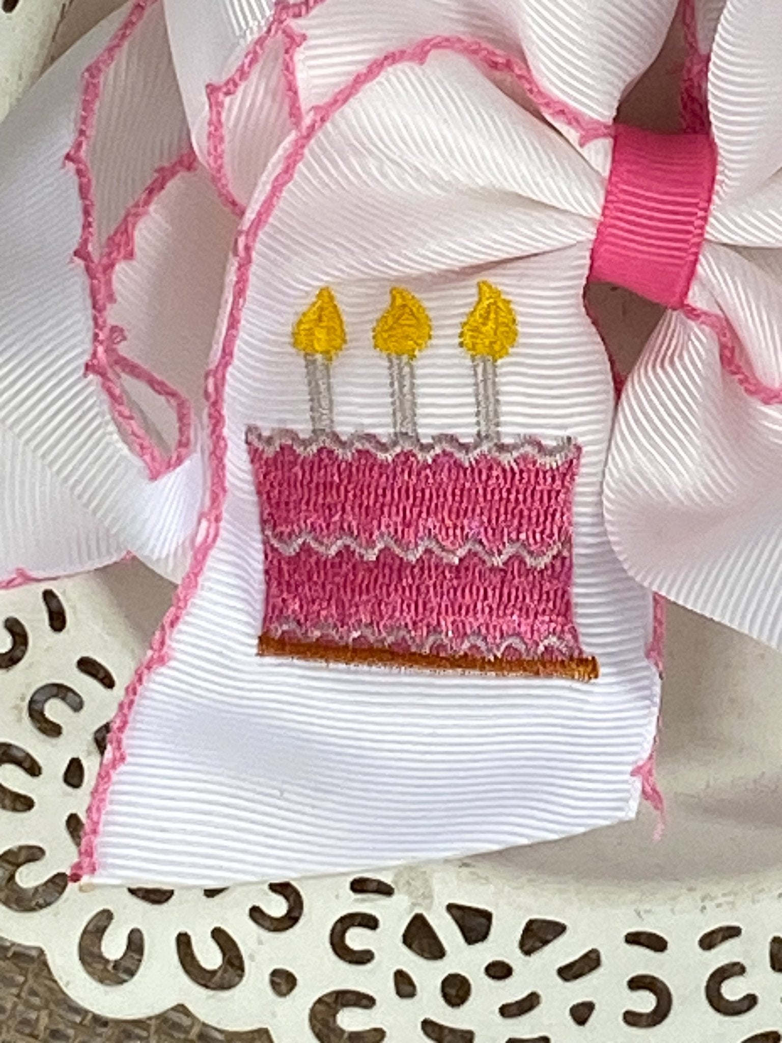 Close up  of the Birthday Cake Embroidered Moonstitch Hair Bow