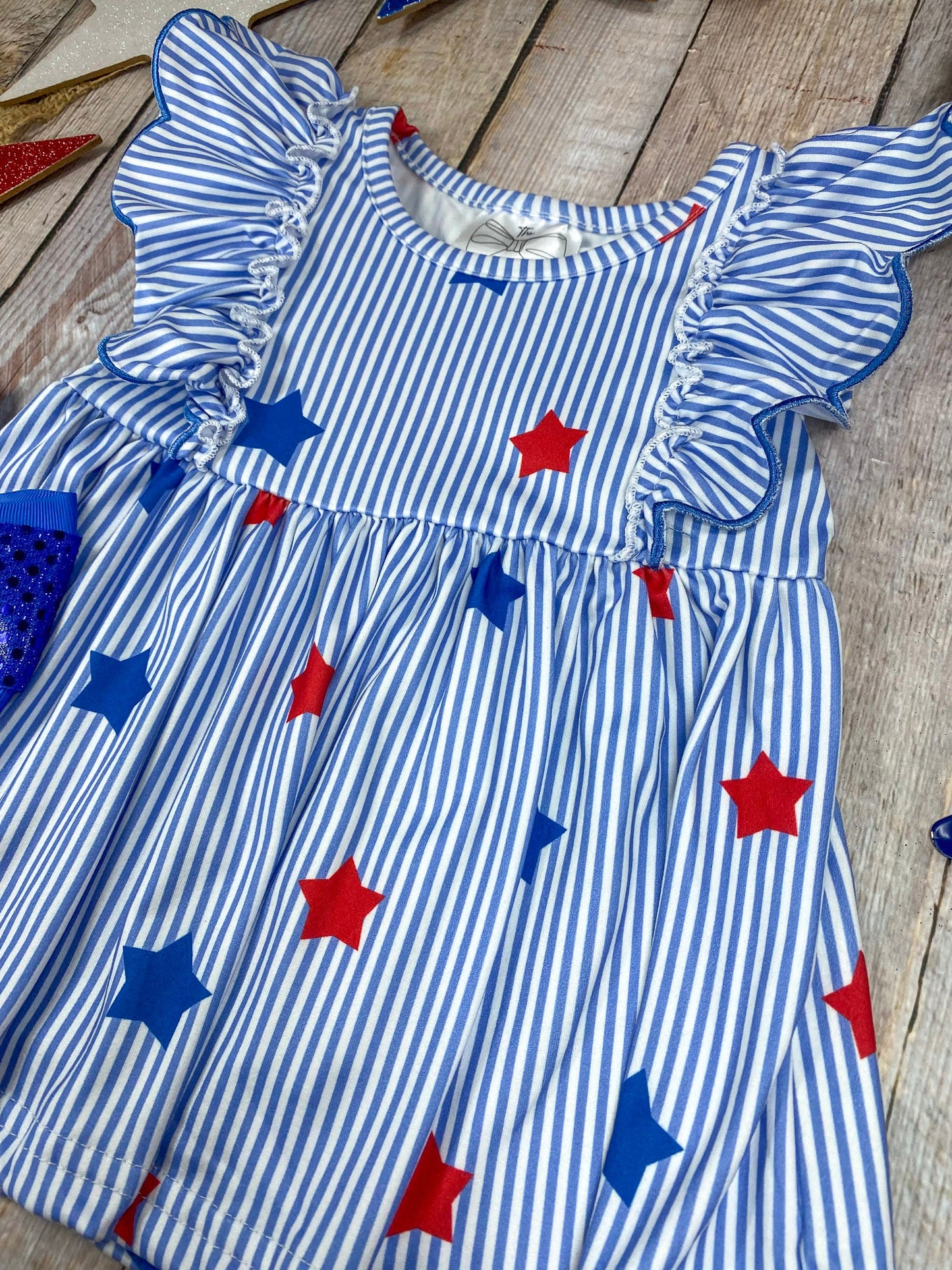 Stars & Stripes Ruffle Shorts Set on a wooden background