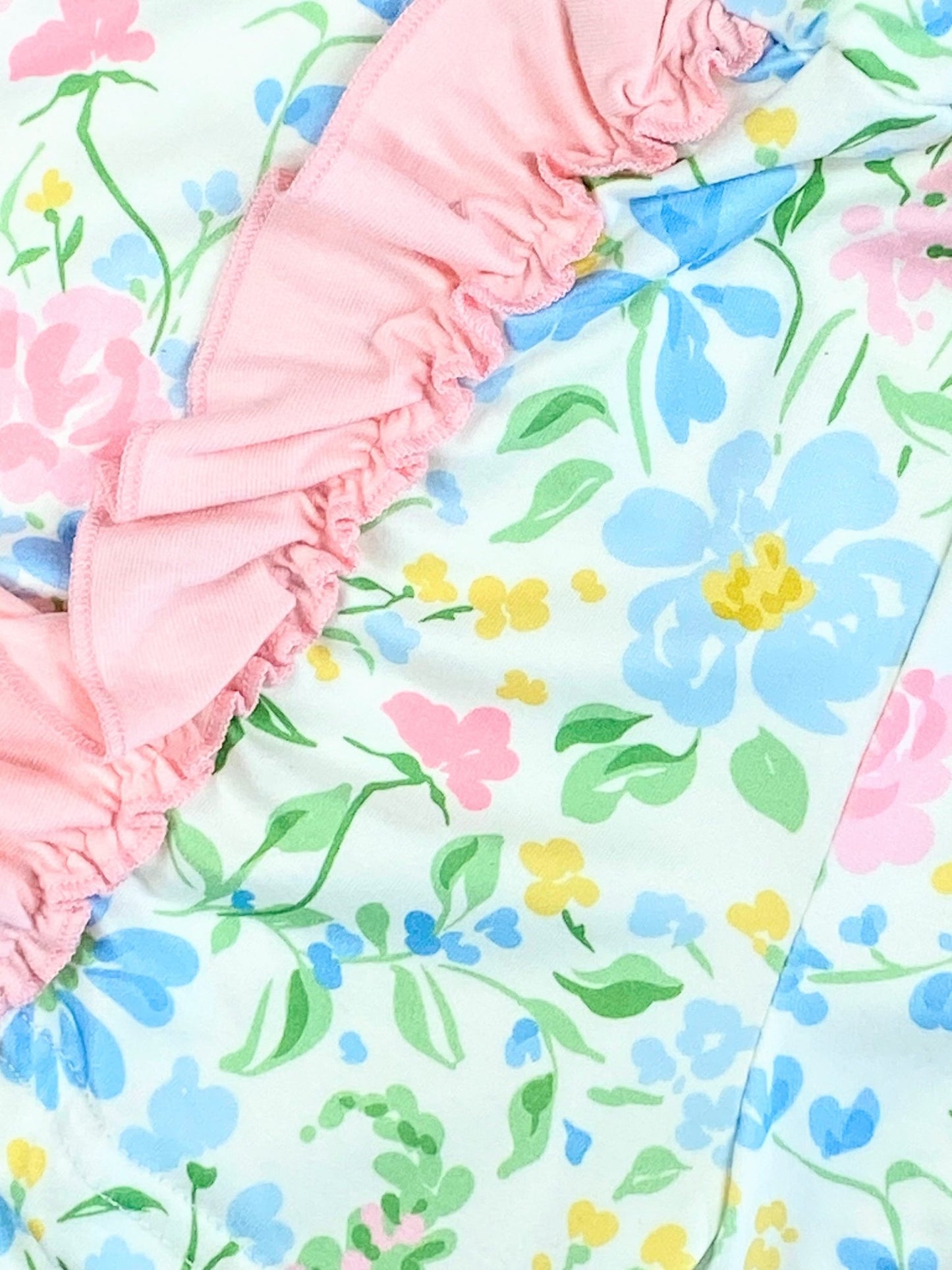 Close up detail photo showing floral design and ruffles on shorts