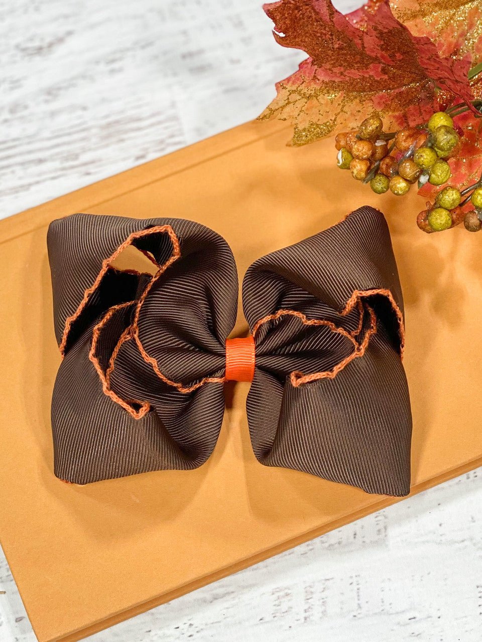Our moonstitch hair bows are made with 2.25" ribbon and measure approximately 4-5 inches in width with contrast stitch edging.