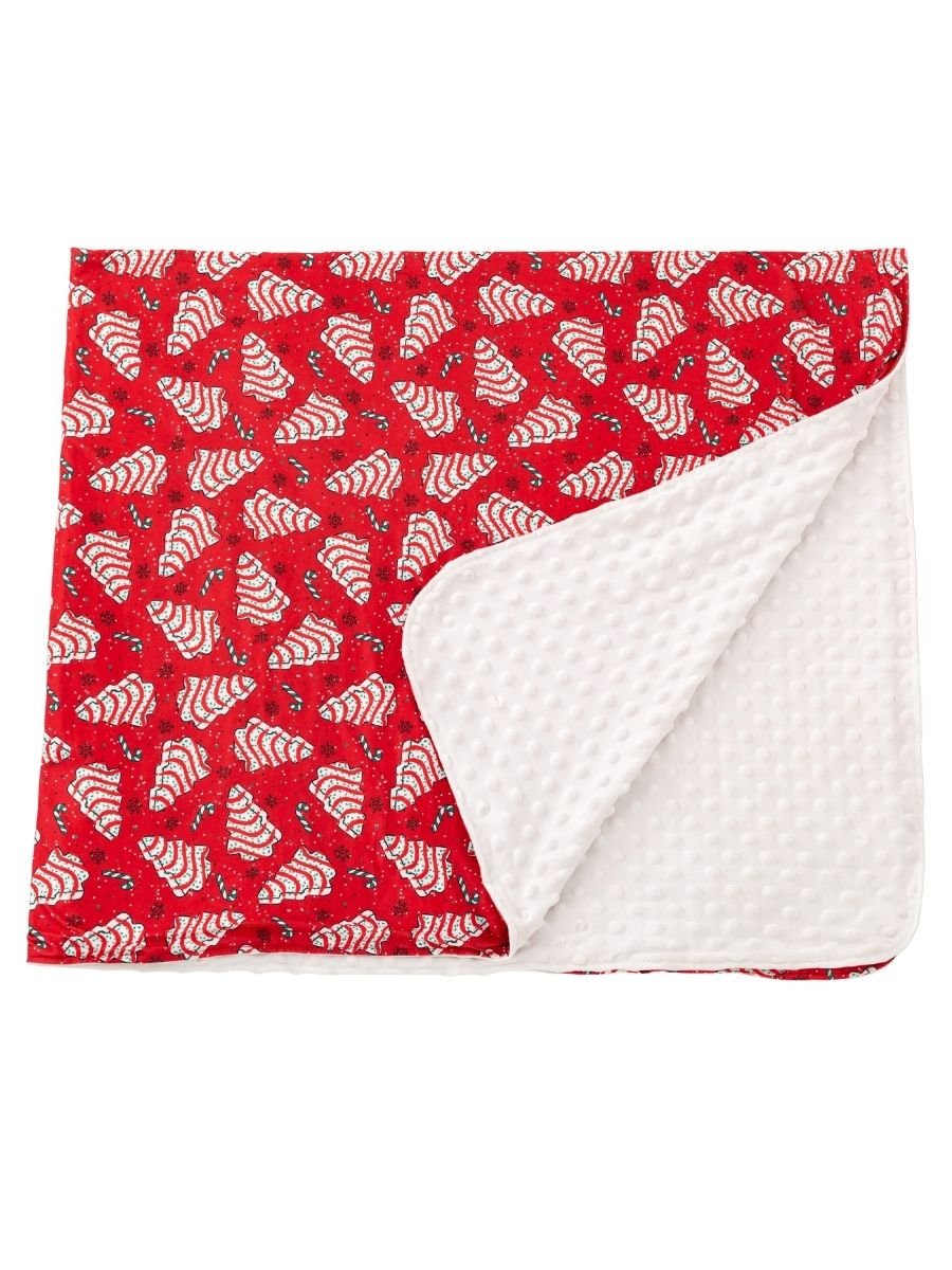 Christmas tree cake minky throw blanket with festive red holiday print and ultra-soft white dotted plush backing.