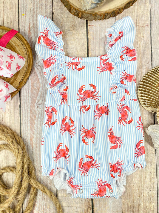 Baby romper with red crab pattern on a wooden background - Alternative view
