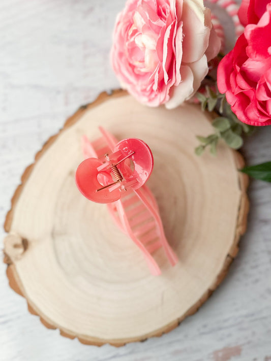 Pink coquette bow hair claw clip on wooden surface with pink flowers - Alternative view