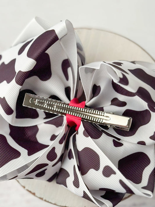 Back of cow print hair bow showing single prong alligator clip - Alternative view