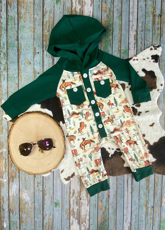 Children's outfit with green hoodie, patterned shirt, and cowhide rug on a wooden surface - Alternative view