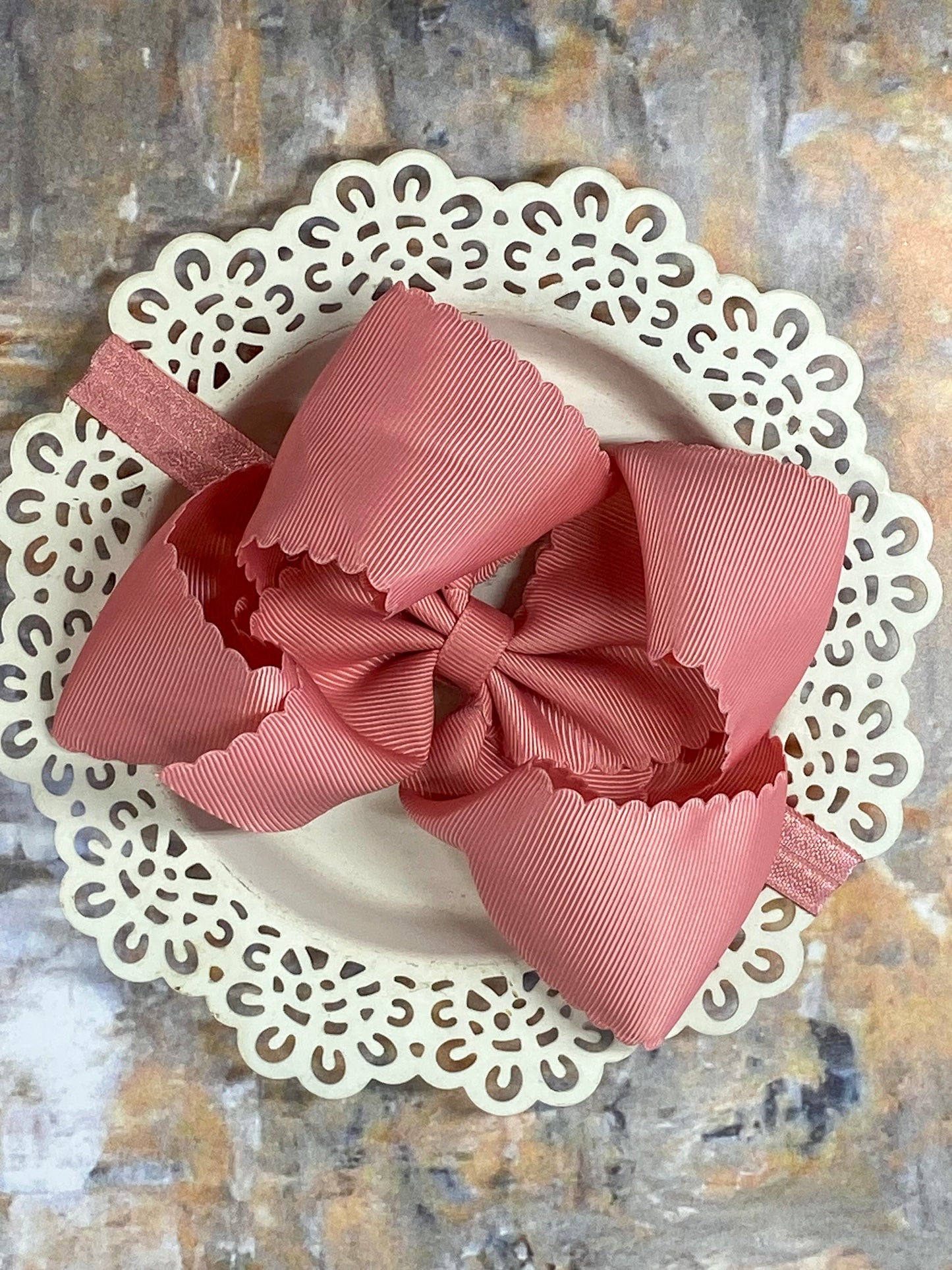 dusty rose scalloped hair bow on a headband