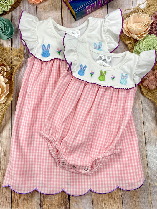 Pink checkered sibling dress and romper with embroidered bunny designs on a wooden surface - Alternative view