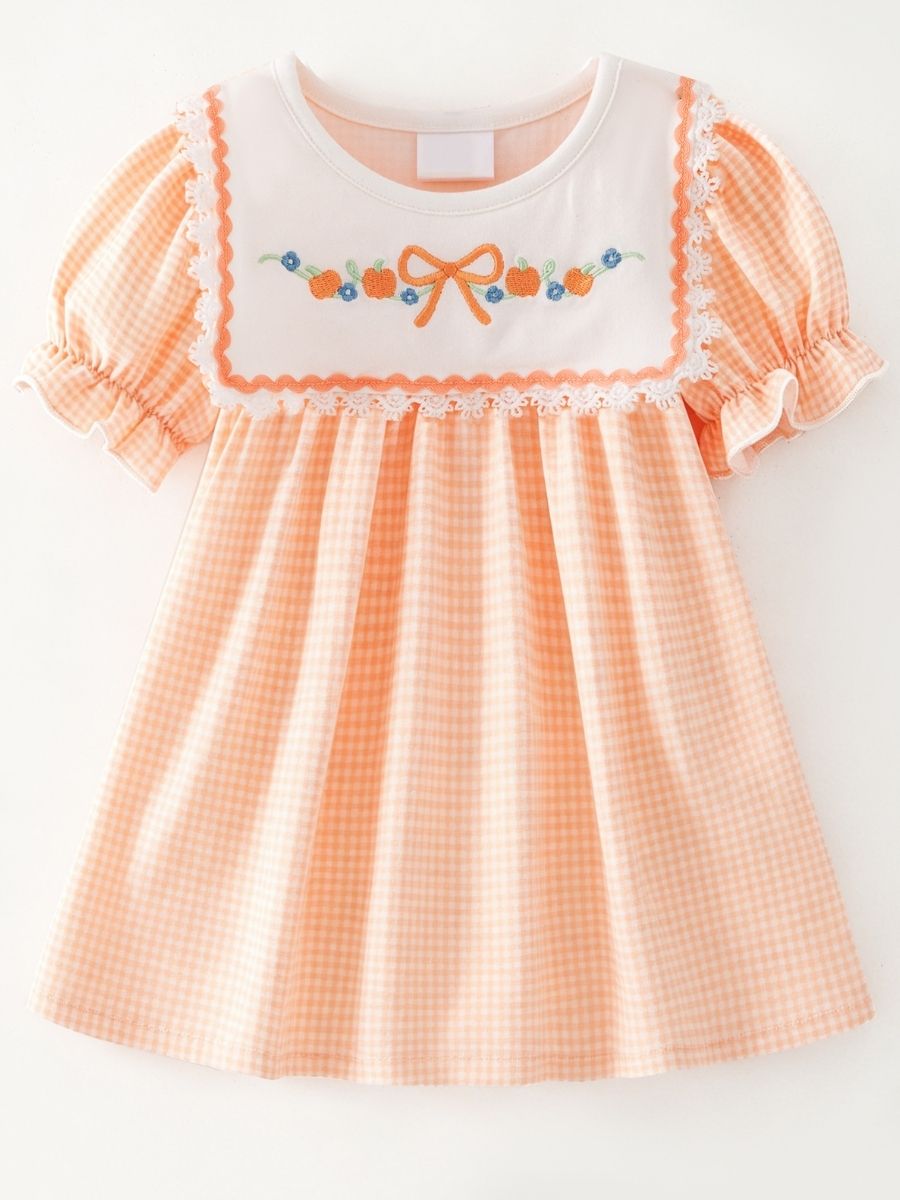 girls fall boutique dress with pumpkin embroidery on peach gingham and lace bib detail