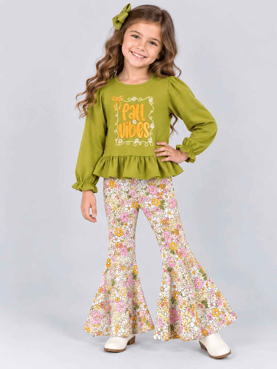Girl wearing the olive fall vibes top and floral bell bottoms