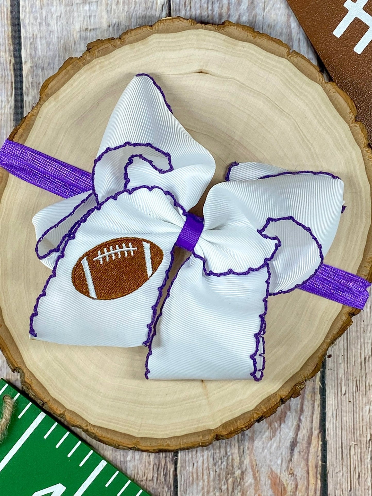 Football Embroidered Moonstitch Bow Headband with purple stitching