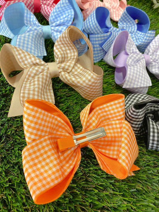 Colorful checkered hair bows on a grass background - Alternative view