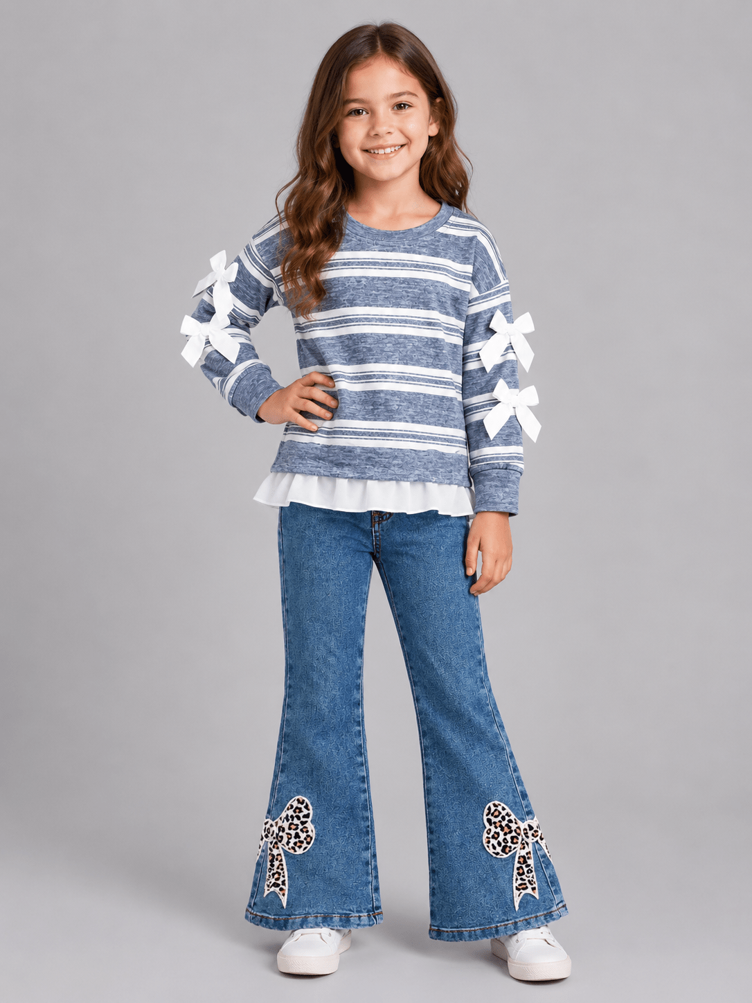 Girls blue striped long sleeve top with white sleeve bows and ruffle hem