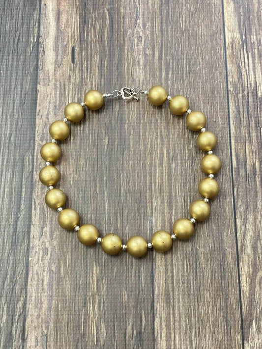 Gold chunky bead necklace on a wood table - Alternative view