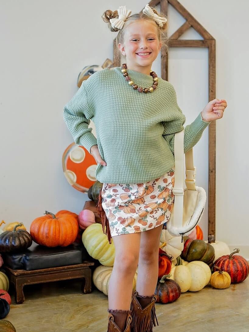 model of sweater and fringe skirt set