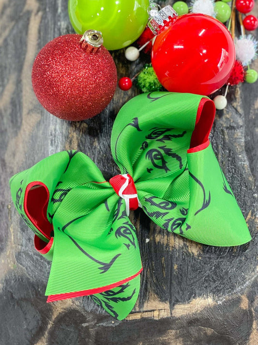 Grinch face double ribbon bow measures approx. 5.5" across and comes on an alligator clip with teeth.