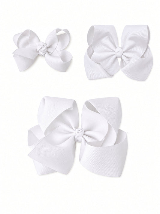 Three white grosgrain hair bows in small, medium and large sizes on a white background - Alternative view