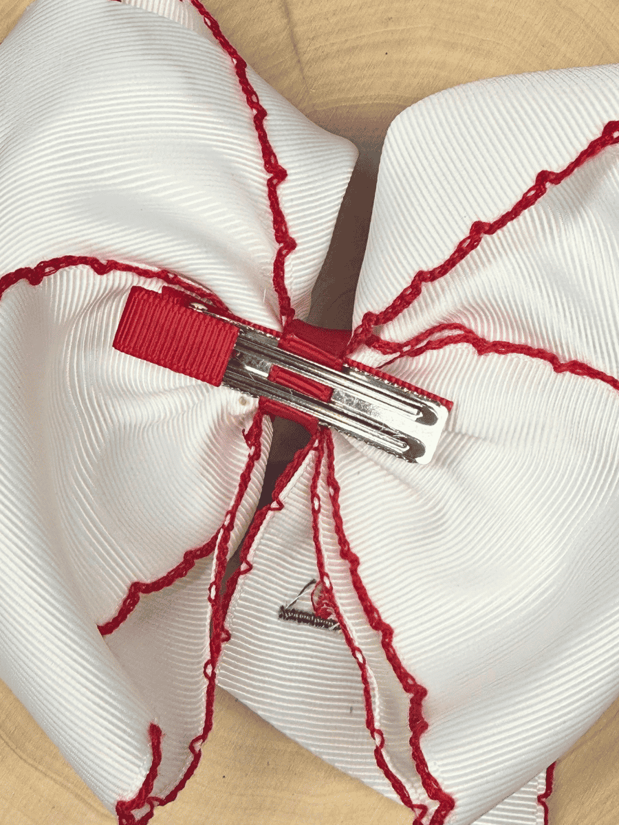 Back of Little Red Farmhouse Barn hair bow with alligator clip attachment