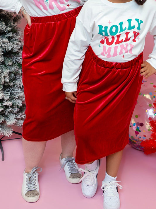 Mom and daughter in red velvet skirts by a Christmas tree - Alternative view