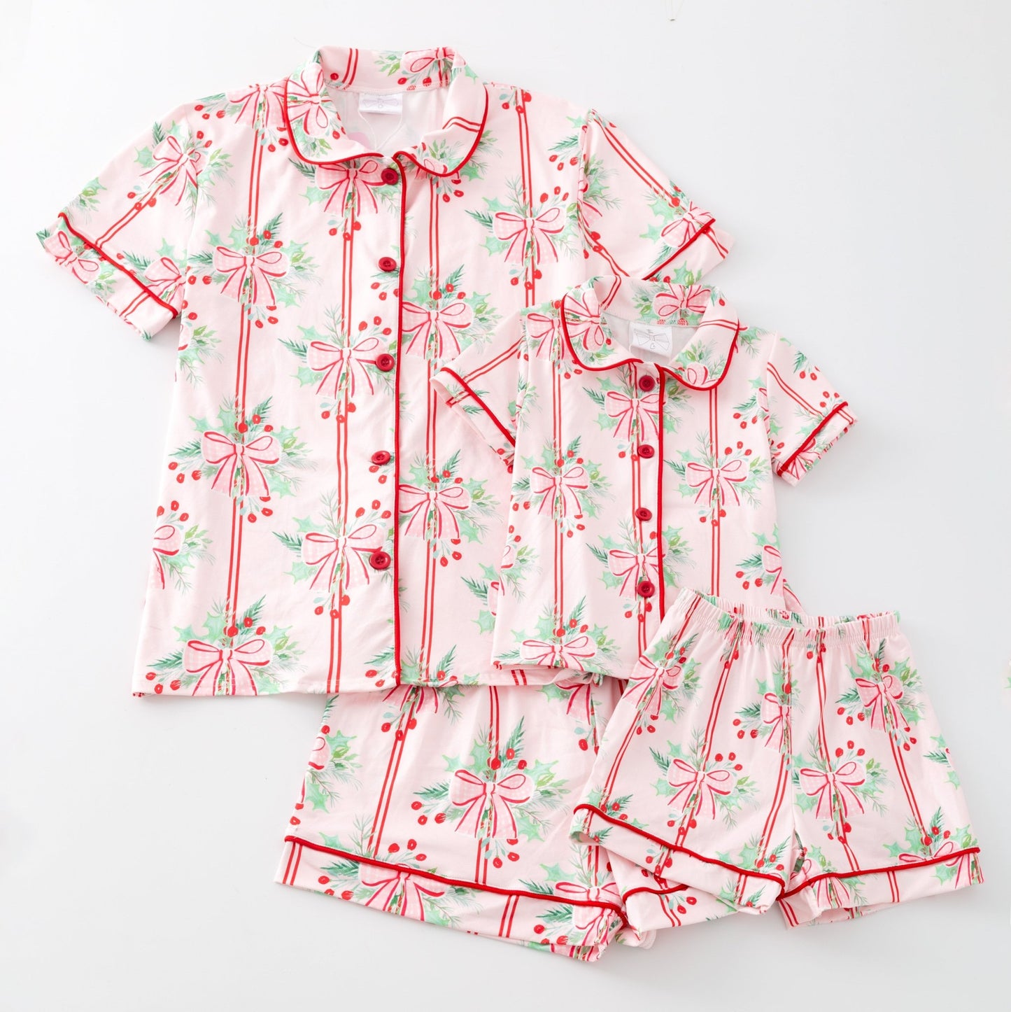 Children's pajama set & moms set with red bows and green leaves on a white background