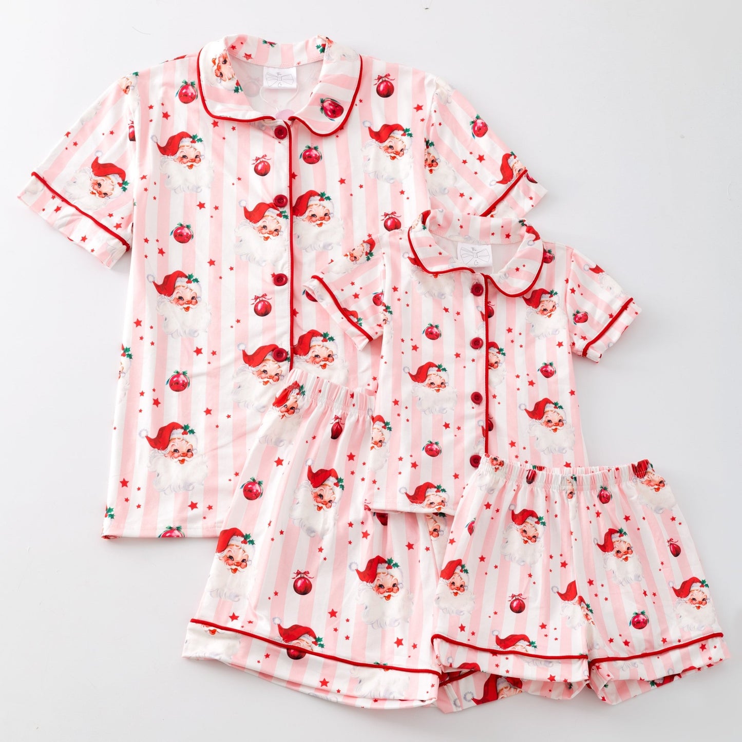 Pink pajama set with santa pattern on a light gray background