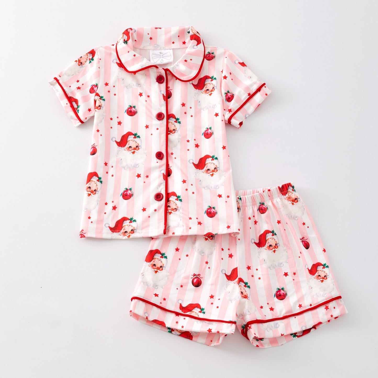Children's pajama set with red and white pattern on a light gray background