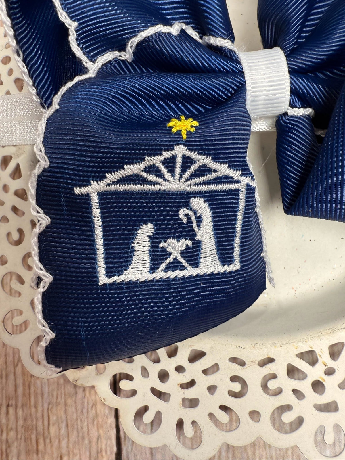 Close-up of nativity scene embroidery on hair bow