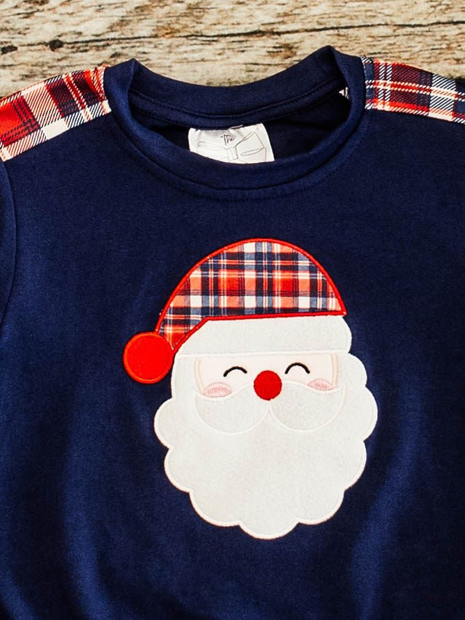 close up showing the santa wearing a plaid hat applique and the plaid detail on the shoulders