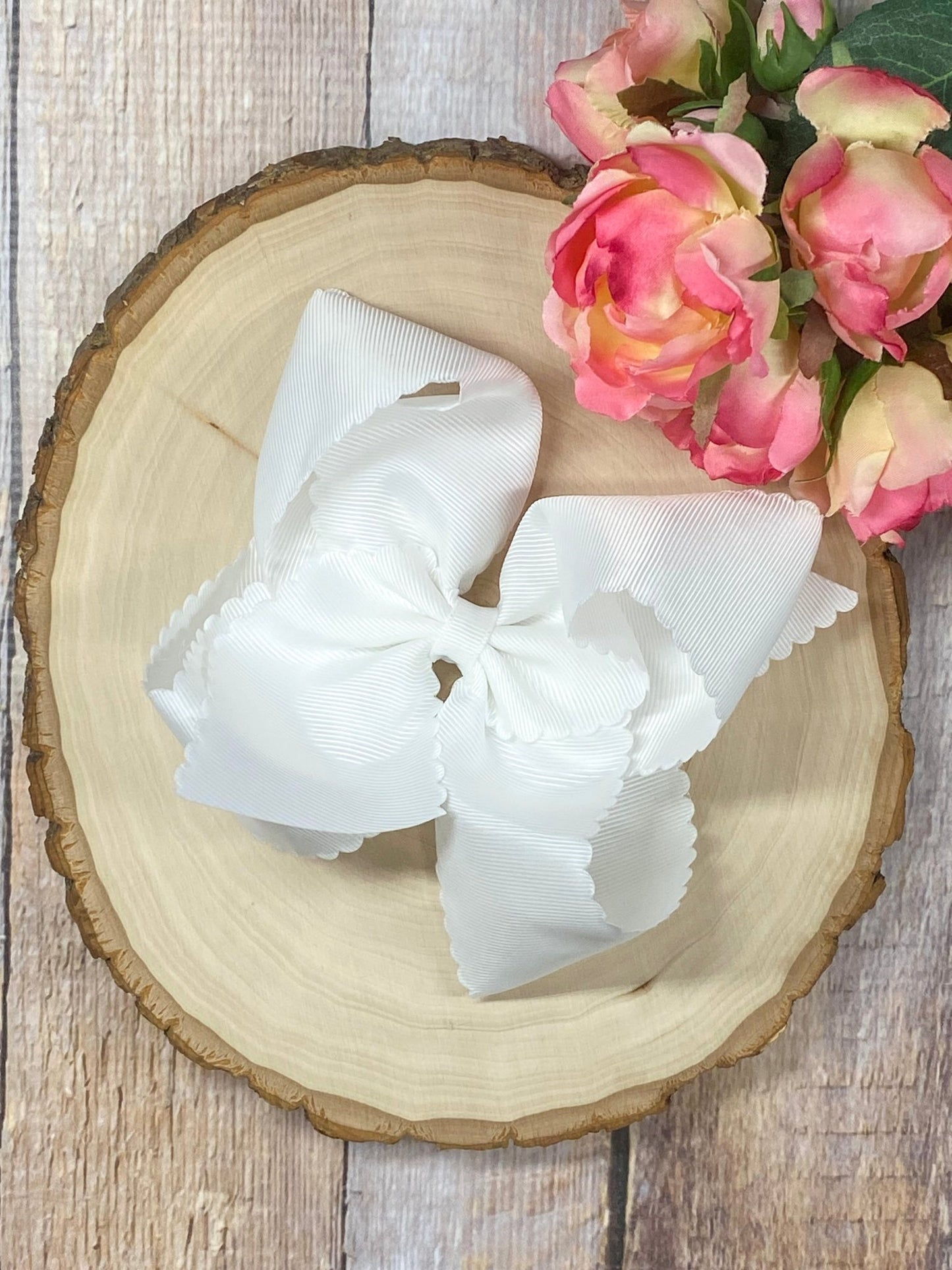 White hair bow on wooden display