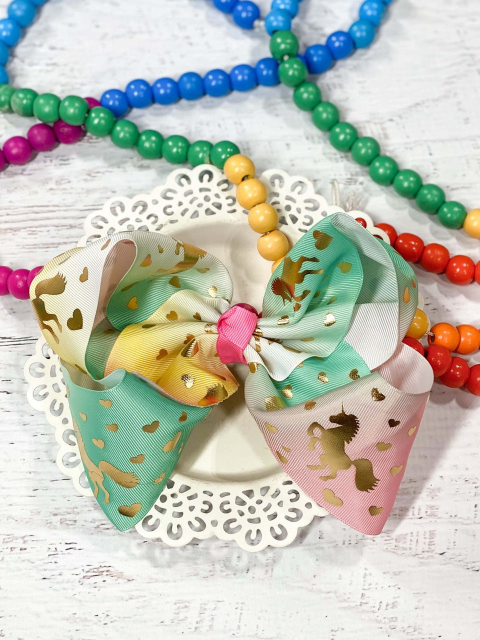 Unicorn hair bow in pastel rainbow and gold foil print.