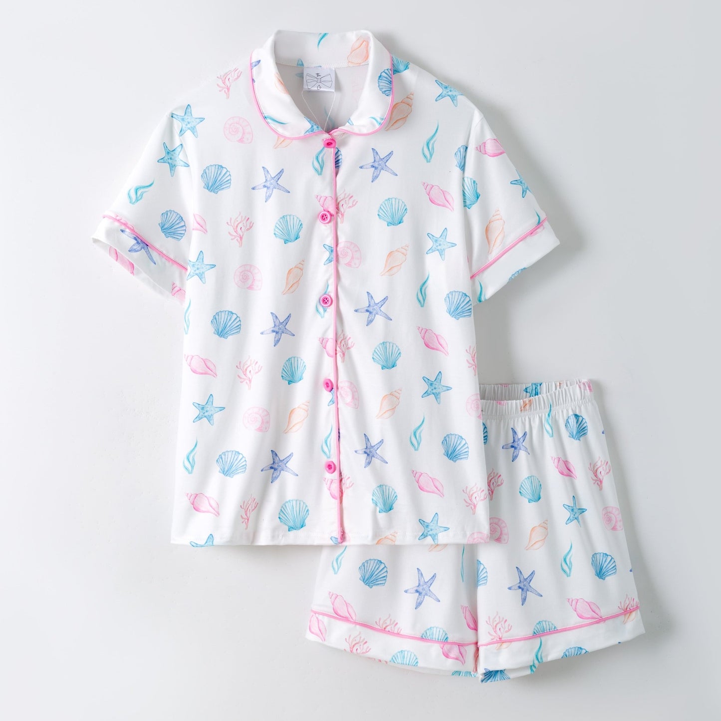 Children's pajama set with sea-themed pattern on a light gray background