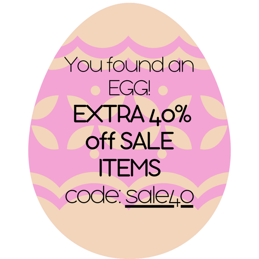 Pink and beige Easter egg-shaped sign with promotional text and code. - Alternative view